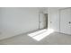 Sunlit bedroom with neutral carpet, white walls, and a closet with sliding doors at 11946 Glide Reflection Ave, Las Vegas, NV 89138