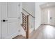 Bright entryway featuring wood-look floors and a staircase with black metal railings at 11946 Glide Reflection Ave, Las Vegas, NV 89138