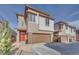 Beautiful two-story home featuring an orange door and a two-car garage at 11946 Glide Reflection Ave, Las Vegas, NV 89138