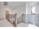 Upstairs hallway with modern metal railing and carpet at 11946 Glide Reflection Ave, Las Vegas, NV 89138