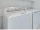Laundry area featuring white, modern, GE washer and dryer units at 11946 Glide Reflection Ave, Las Vegas, NV 89138