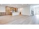 Open-concept living space with wood-look floors adjacent to a kitchen at 11946 Glide Reflection Ave, Las Vegas, NV 89138