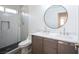 Bright bathroom featuring double sinks, modern fixtures, and a walk-in shower with stylish tiling at 1620 Western Lily St, Las Vegas, NV 89128