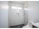 Elegant bathroom shower with herringbone-patterned tile floor and shower niche at 1620 Western Lily St, Las Vegas, NV 89128