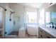 Beautiful bathroom with a glass shower, soaking tub, and stylish vanity at 1620 Western Lily St, Las Vegas, NV 89128