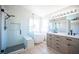 Modern bathroom featuring glass shower, soaking tub, and double vanity at 1620 Western Lily St, Las Vegas, NV 89128