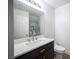 Bathroom features a dark vanity with white countertop and modern fixtures at 1620 Western Lily St, Las Vegas, NV 89128