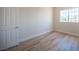 Cozy bedroom with wood-look flooring and natural light from the window at 1620 Western Lily St, Las Vegas, NV 89128