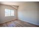 Bedroom with wood-look flooring, white walls, and bright window view at 1620 Western Lily St, Las Vegas, NV 89128