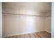 A closet with hanging rods and wood-style flooring at 1620 Western Lily St, Las Vegas, NV 89128