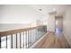 Hallway with modern wood and metal railing and wood-look flooring at 1620 Western Lily St, Las Vegas, NV 89128