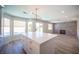 Large kitchen island with quartz countertop with direct view of the pool outside the bay windows at 1620 Western Lily St, Las Vegas, NV 89128