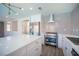 Bright kitchen featuring white cabinetry, stainless steel appliances, tile backsplash, and center island at 1620 Western Lily St, Las Vegas, NV 89128