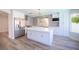 Bright kitchen featuring white cabinetry, stainless steel appliances, and a large center island at 1620 Western Lily St, Las Vegas, NV 89128