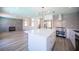 Bright kitchen featuring white cabinetry, stainless steel appliances, fireplace, and center island at 1620 Western Lily St, Las Vegas, NV 89128