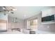 Bright kitchen featuring white cabinetry, stainless steel appliances, tile backsplash, and modern lighting at 1620 Western Lily St, Las Vegas, NV 89128