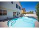 Inviting backyard pool with a step-in entrance and a patio for outdoor entertaining at 1620 Western Lily St, Las Vegas, NV 89128