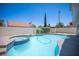 Sparkling backyard pool and spa surrounded by lush landscaping and palm trees at 1620 Western Lily St, Las Vegas, NV 89128