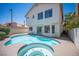 Backyard pool and spa featuring a patio area, with an adjacent home featuring large windows at 1620 Western Lily St, Las Vegas, NV 89128