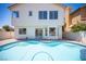 Backyard pool featuring a patio area, with an adjacent home featuring large windows at 1620 Western Lily St, Las Vegas, NV 89128