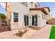 An outdoor patio featuring two rocking chairs and a well manicured backyard space at 1887 Hollywell St, Las Vegas, NV 89135