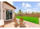 Inviting backyard with patio, artificial turf, desert landscaping, and a serene ambiance perfect for relaxation at 1887 Hollywell St, Las Vegas, NV 89135