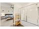 A bathroom featuring a modern shower, with natural light and a bedroom in the background at 1887 Hollywell St, Las Vegas, NV 89135