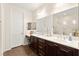 A luxurious bathroom featuring double sinks, modern fixtures, and a large mirror at 1887 Hollywell St, Las Vegas, NV 89135