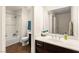Bathroom featuring a tub/shower, tile flooring, vanity with sink, and a large mirror at 1887 Hollywell St, Las Vegas, NV 89135