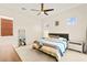 Serene bedroom featuring neutral tones, a ceiling fan, and ample natural light, creating a peaceful retreat at 1887 Hollywell St, Las Vegas, NV 89135