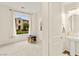 A well-lit bedroom with a charming window overlooking a serene outdoor view at 1887 Hollywell St, Las Vegas, NV 89135
