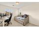 Bedroom featuring a comfortable daybed, desk with computer, and natural light from two windows at 1887 Hollywell St, Las Vegas, NV 89135