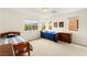 Bright bedroom with two twin beds, dresser, and large windows offering a scenic view at 1887 Hollywell St, Las Vegas, NV 89135