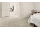 A bedroom with neutral tones, a closet, and an open doorway leading to an office space at 1887 Hollywell St, Las Vegas, NV 89135