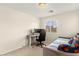 Bedroom showcasing a desk with computer, a comfortable daybed, and a view of the neighborhood at 1887 Hollywell St, Las Vegas, NV 89135