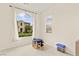 A bright bedroom with a large arched window that provides ample natural light and a pleasant view at 1887 Hollywell St, Las Vegas, NV 89135