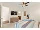 Cozy bedroom featuring a view into the bathroom, a ceiling fan, and stylish furnishings for a comfortable living space at 1887 Hollywell St, Las Vegas, NV 89135