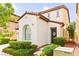 Beautifully landscaped home with a two-story facade, decorative architectural details, and a welcoming entrance at 1887 Hollywell St, Las Vegas, NV 89135