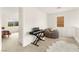 Bright landing area with a keyboard, beanbag chair, and view into another room, all illuminated by natural light at 1887 Hollywell St, Las Vegas, NV 89135