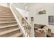 Elegant staircase leading to a cozy living area with plush seating and ample natural light at 1887 Hollywell St, Las Vegas, NV 89135