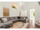 Inviting living room featuring a large sectional sofa, high ceilings, and abundant natural light at 1887 Hollywell St, Las Vegas, NV 89135