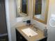 Bathroom with granite vanity countertop with framed mirror at 1927 Raspberry Hill Rd, Las Vegas, NV 89142