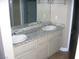 Double sink bathroom featuring granite countertops and modern fixtures at 1927 Raspberry Hill Rd, Las Vegas, NV 89142