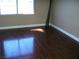 Bedroom featuring hardwood flooring and a window for natural light at 1927 Raspberry Hill Rd, Las Vegas, NV 89142