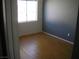 This bedroom features hardwood floors and neutral paint at 1927 Raspberry Hill Rd, Las Vegas, NV 89142