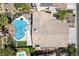 Aerial view of a private backyard featuring a large pool, built in spa, and covered patio area with turf at 2113 Waterbury Ln, Las Vegas, NV 89134