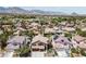 Scenic aerial view of a residential neighborhood with mature trees, diverse home styles, and mountain backdrop at 2113 Waterbury Ln, Las Vegas, NV 89134