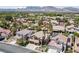 Beautiful aerial shot of a neighborhood with mountain views, lush greenery, and well-maintained homes at 2113 Waterbury Ln, Las Vegas, NV 89134