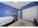 The bedroom has hardwood floors, a bed, and is painted with a cozy, fun color at 2113 Waterbury Ln, Las Vegas, NV 89134