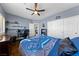 The bedroom features neutral walls, and a ceiling fan with blue-themed beddings at 2113 Waterbury Ln, Las Vegas, NV 89134